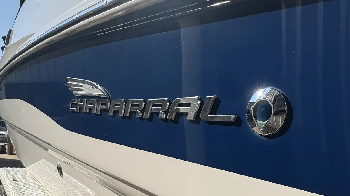 After: the same Chaparral logo panel, glossy deep blue after Dirty Work’s gelcoat restoration